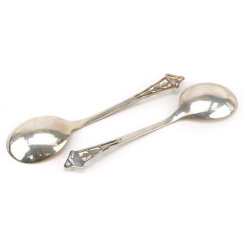 162 - E S Barnsley & Co, pair of Arts & Crafts silver desert spoons, the terminals pierced with stylised f... 