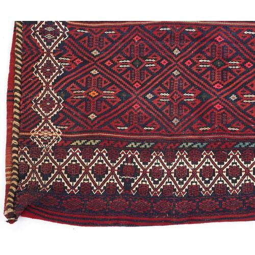 2207 - Rectangular Afghan red ground saddle bag having an allover repeat design, 150cm x 80cm