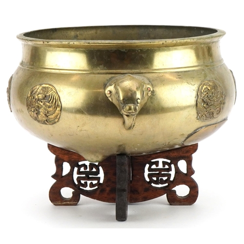 654 - Large Chinese bronze tripod censer with elephant head handles on hardwood stand with applied roundel... 