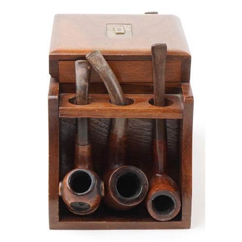 1321 - Twenty four vintage tobacco smoking pipes arranged in three pipe racks with tobacco boxes, some clay... 