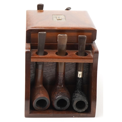 1321 - Twenty four vintage tobacco smoking pipes arranged in three pipe racks with tobacco boxes, some clay... 