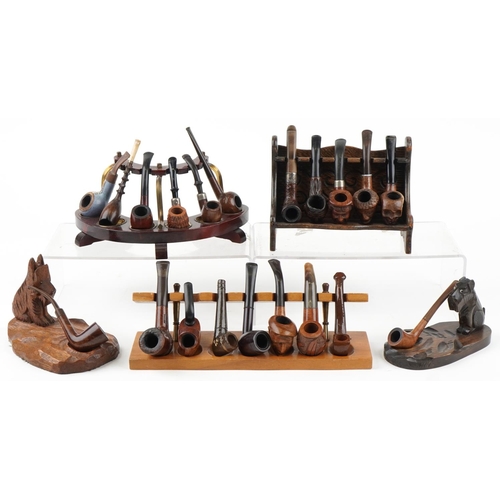 1272 - Twenty vintage tobacco smoking pipes, some briar examples arranged in five pipe racks/stands, two ca... 