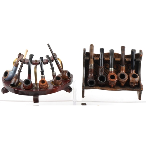 1272 - Twenty vintage tobacco smoking pipes, some briar examples arranged in five pipe racks/stands, two ca... 