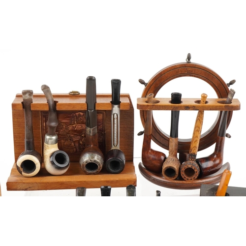 1295 - Nineteen vintage tobacco smoking pipes, some briar, some European, arranged in four pipe racks inclu... 