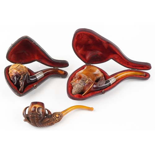 1251 - Three Meerschaum smoking pipes, two housed in velvet lined fitted cases, comprising bowls carved in ... 