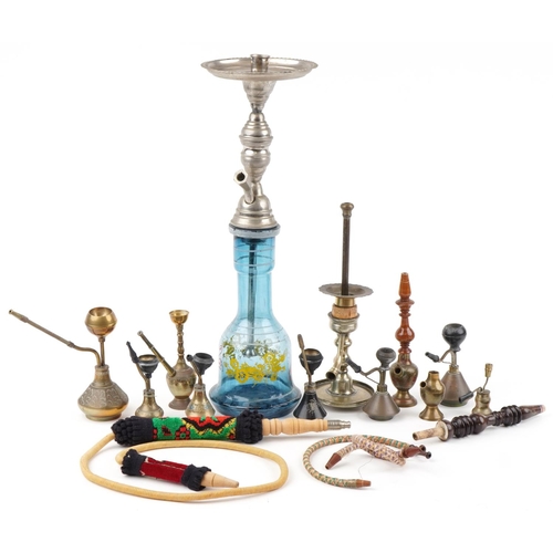 1318 - Continental tobacco smoking pipes including a glass shisha enamelled with flowers, 57cm high