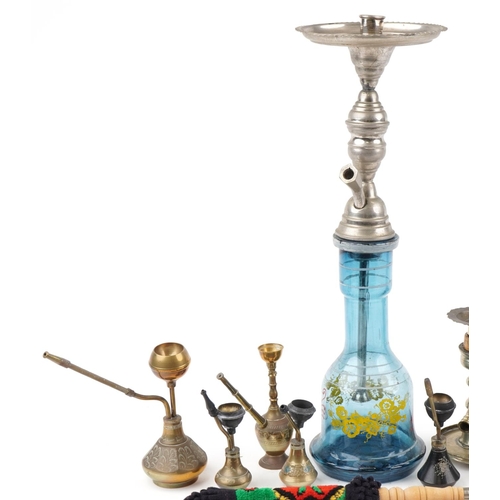 1318 - Continental tobacco smoking pipes including a glass shisha enamelled with flowers, 57cm high