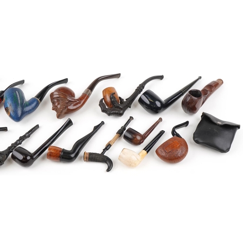 1312 - Sixteen antique and later tobacco smoking pipes including a good quality example carved in the form ... 