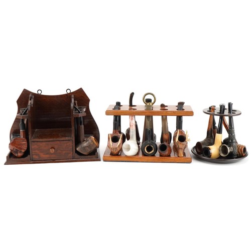 1267 - Twenty tobacco smoking pipes, some briar, arranged in three pipe racks including Dr Plumb and Kay Wo... 