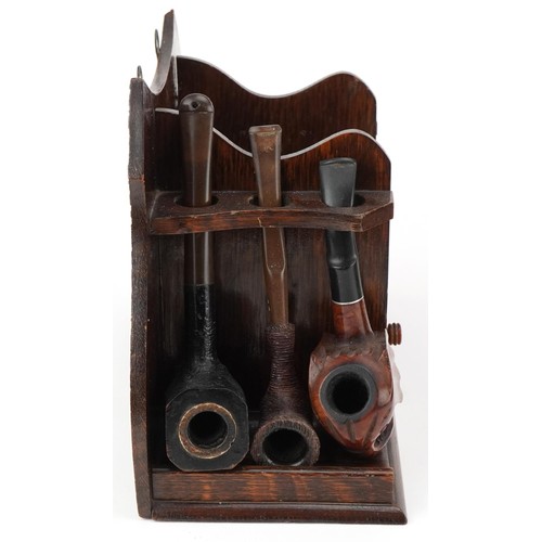 1267 - Twenty tobacco smoking pipes, some briar, arranged in three pipe racks including Dr Plumb and Kay Wo... 