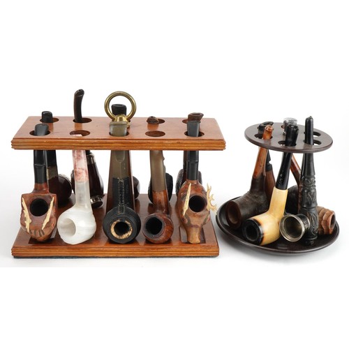 1267 - Twenty tobacco smoking pipes, some briar, arranged in three pipe racks including Dr Plumb and Kay Wo... 