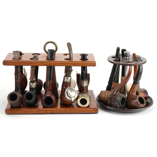 1267 - Twenty tobacco smoking pipes, some briar, arranged in three pipe racks including Dr Plumb and Kay Wo... 