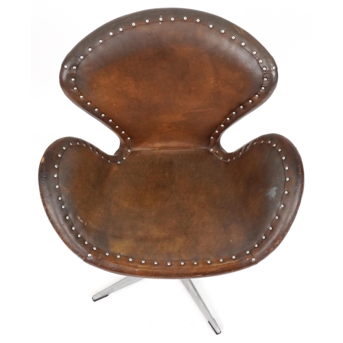 2041 - Timothy Oulton aviation interest Devon Spitfire swivel chair with brown leather upholstery, 90cm hig... 