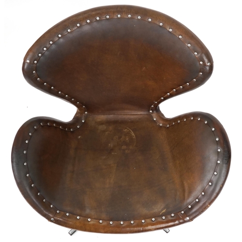 2042 - Timothy Oulton aviation interest Devon Spitfire swivel chair with brown leather upholstery, 90cm hig... 