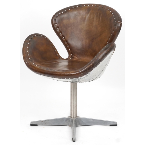 2117 - Timothy Oulton aviation interest Devon Spitfire swivel chair with brown leather upholstery, 90cm hig... 