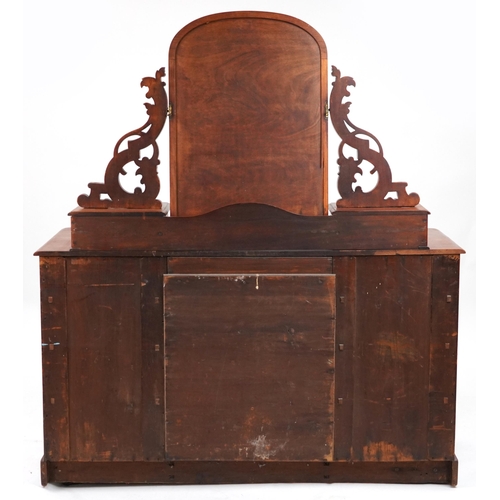 2032 - Ornate Victorian mahogany dressing chest with swing mirror fitted with an arrangement of ten drawers... 