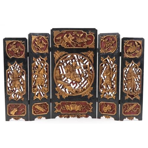 531 - Chinese partially gilt red and black lacquered wood five fold screen pierced and carved with panels ... 