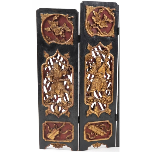 531 - Chinese partially gilt red and black lacquered wood five fold screen pierced and carved with panels ... 