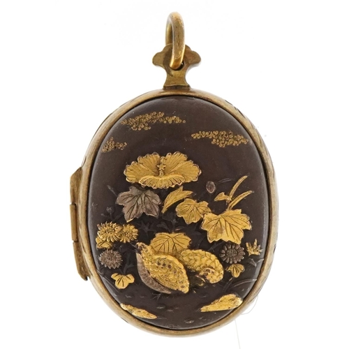 Good Japanese Shakudo mixed metal locket decorated in relief with two quails amongst flowers and a junk before Mount Fuji, 4cm high