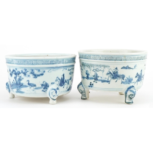 645 - Two Chinese blue and white porcelain tripod censers decorated with figures in landscapes, each 19cm ... 