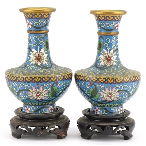 530 - Pair of Chinese cloisonne vases raised on hardwood stands enamelled with flowers amongst scrolling f... 