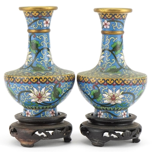 530 - Pair of Chinese cloisonne vases raised on hardwood stands enamelled with flowers amongst scrolling f... 