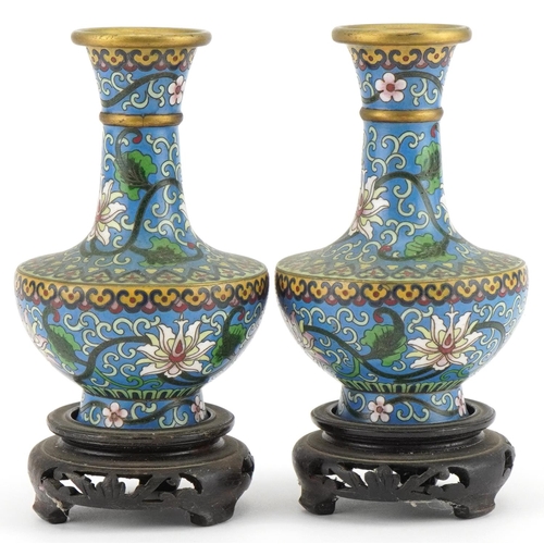 530 - Pair of Chinese cloisonne vases raised on hardwood stands enamelled with flowers amongst scrolling f... 