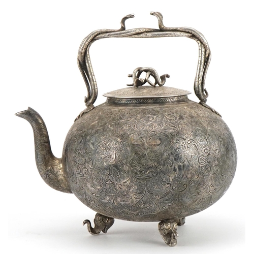 99 - Good Indian white metal teapot with serpent handles and knop finely engraved with deities amongst fl... 