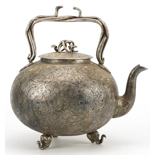 99 - Good Indian white metal teapot with serpent handles and knop finely engraved with deities amongst fl... 