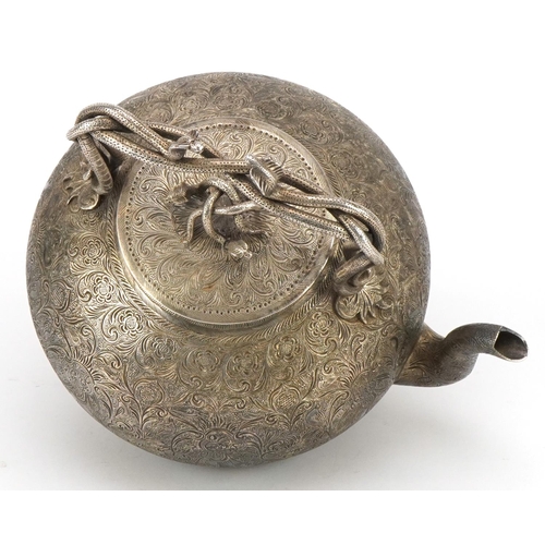 99 - Good Indian white metal teapot with serpent handles and knop finely engraved with deities amongst fl... 