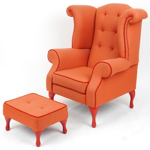 2075 - Contemporary wingback armchair with peach button back upholstery on cabriole legs with matching foot... 