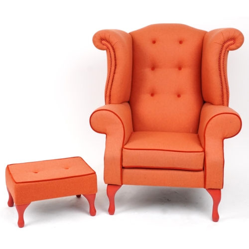 2075 - Contemporary wingback armchair with peach button back upholstery on cabriole legs with matching foot... 