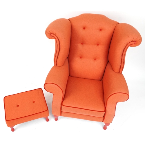 2075 - Contemporary wingback armchair with peach button back upholstery on cabriole legs with matching foot... 