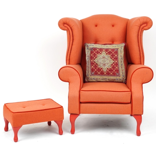 2075 - Contemporary wingback armchair with peach button back upholstery on cabriole legs with matching foot... 