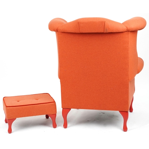 2075 - Contemporary wingback armchair with peach button back upholstery on cabriole legs with matching foot... 