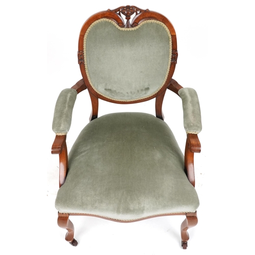 2134 - Victorian style armchair with olive green upholstery on cabriole legs with casters, 95cm high