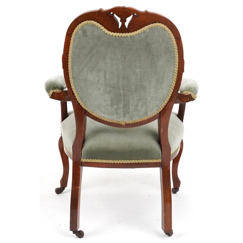 2134 - Victorian style armchair with olive green upholstery on cabriole legs with casters, 95cm high