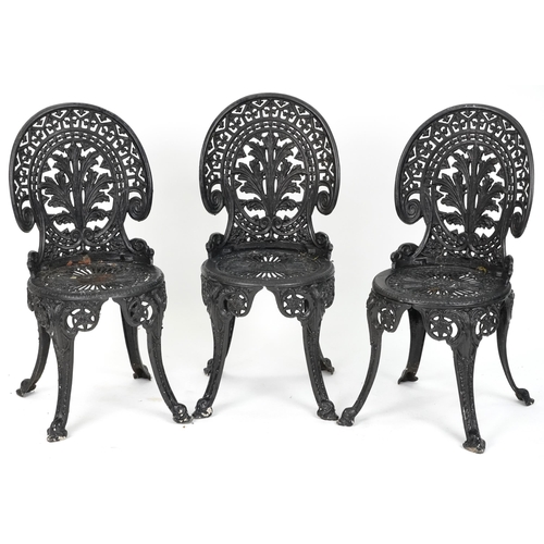 2154 - Black painted cast metal circular garden table with three chairs, 70.5cm high x 69cm in diameter