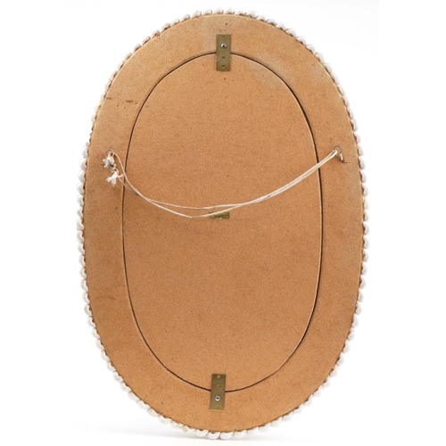 2327 - Philippines oval wall mirror with naturalistic shell border, 77cm x 52.5cm