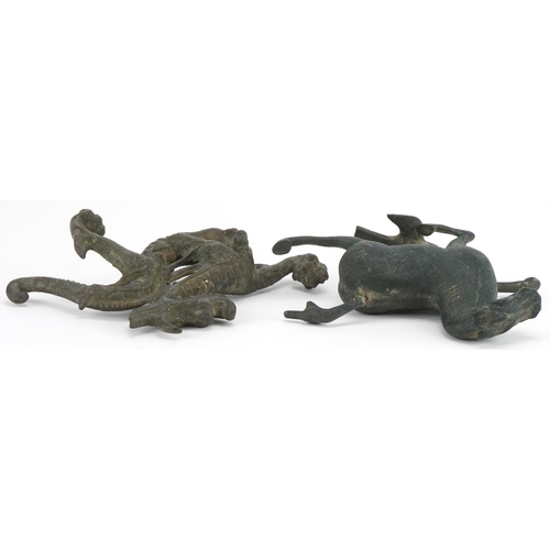 533 - Two Chinese archaic style verdigris cast metal animals including a dragon, each raised on hardwood b... 