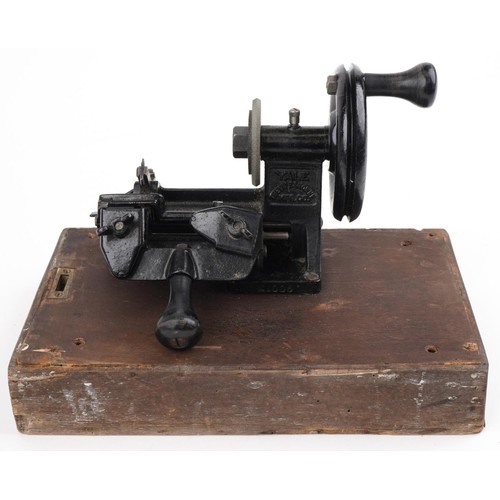 381 - Early 20th century Yale cast iron key cutting machine on rectangular wooden base, overall 34cm wide