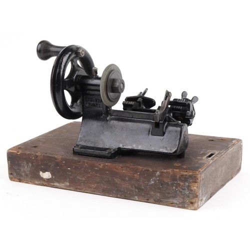 381 - Early 20th century Yale cast iron key cutting machine on rectangular wooden base, overall 34cm wide