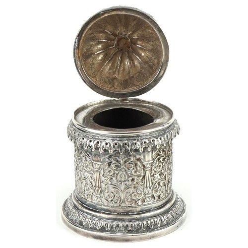 100 - Bhuj, Indian Kutch silver cylindrical pot with hinged lid profusely pierced and embossed with stylis... 