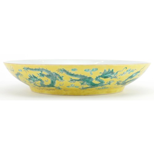 68 - Chinese porcelain yellow ground dish hand painted in green with dragons chasing the flaming pearl am... 