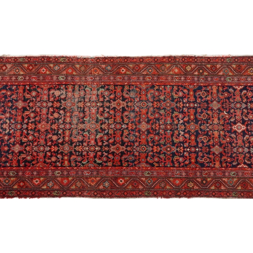 2185 - Rectangular Persian red and blue ground carpet runner having an allover floral repeat central field,... 