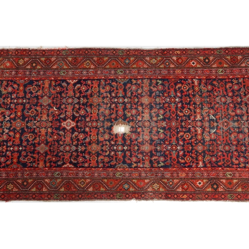 2185 - Rectangular Persian red and blue ground carpet runner having an allover floral repeat central field,... 