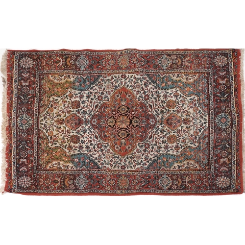 2191 - Rectangular Persian rug with red ground border having and allover repeat floral design, 190cm x 135c... 