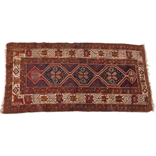 2190 - Rectangular Turkish red ground rug having an allover repeat floral design, 258cm x 132cm