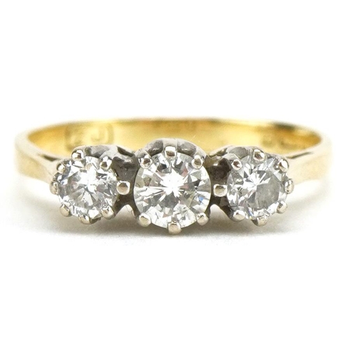 3034 - 18ct gold diamond three stone ring, the central diamond approximately 0.25 carat, size K, 2.4g