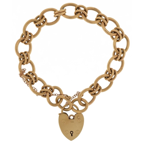 3004 - 9ct gold chain link bracelet with 9ct gold love heart padlock, 18cm in length, 29.7g